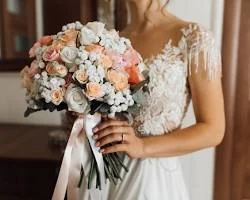 Bride holding bouquet at hip level