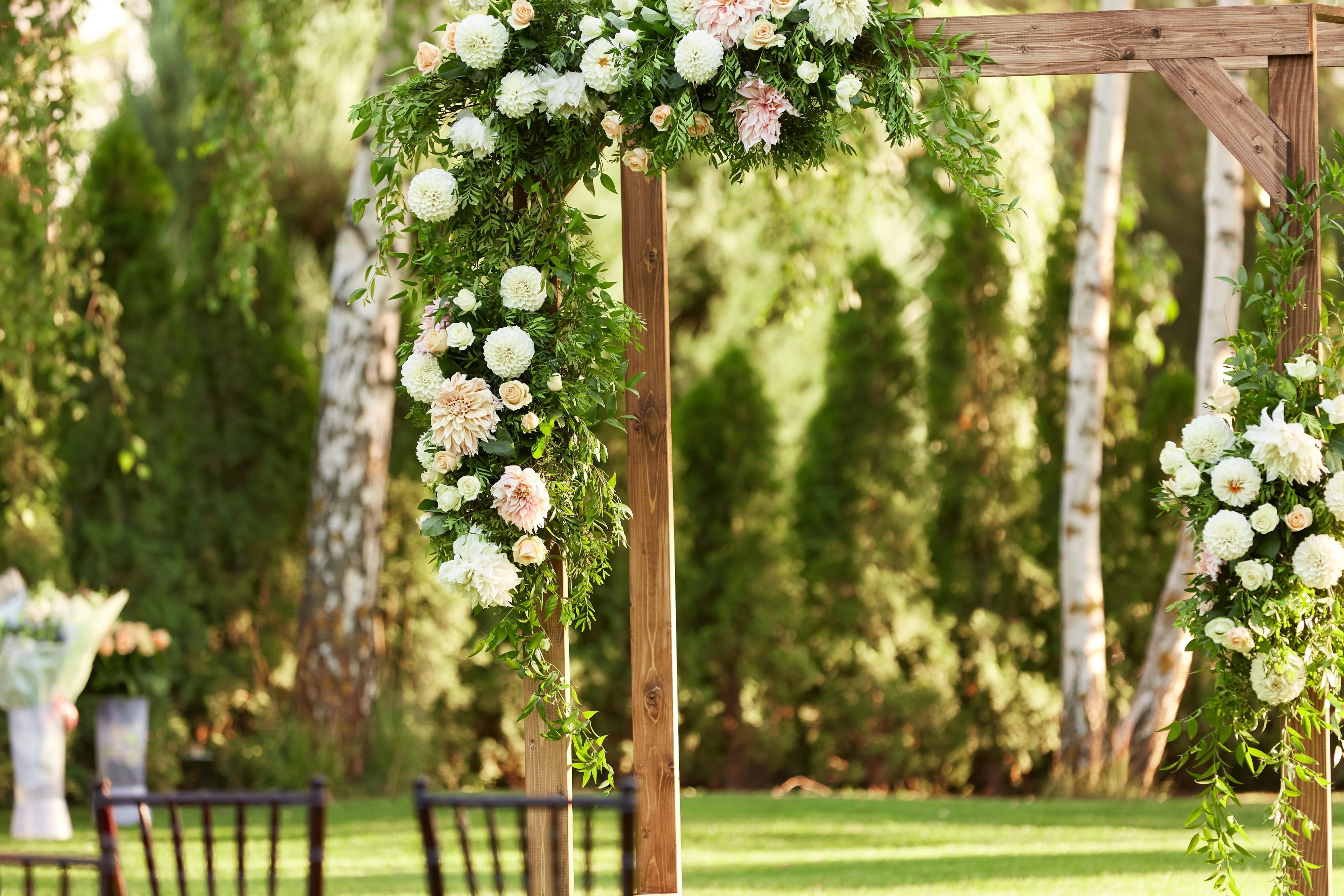 Outdoor ceremony with floral arch